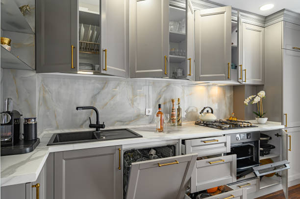 Closeup details of grey and white contemporary classic kitchen designed in modern style cabinets.