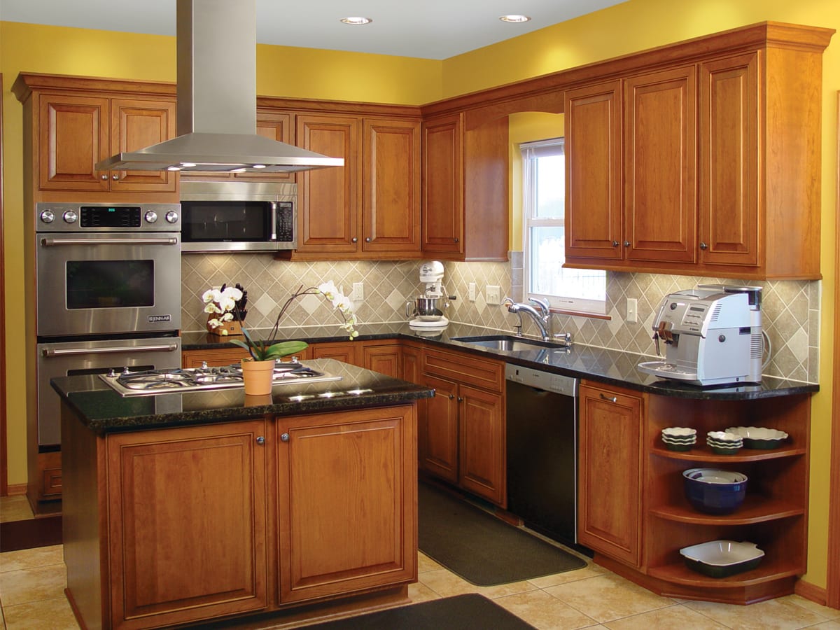 Traditional kitchen remodel with a unique island cooktop and hood - after