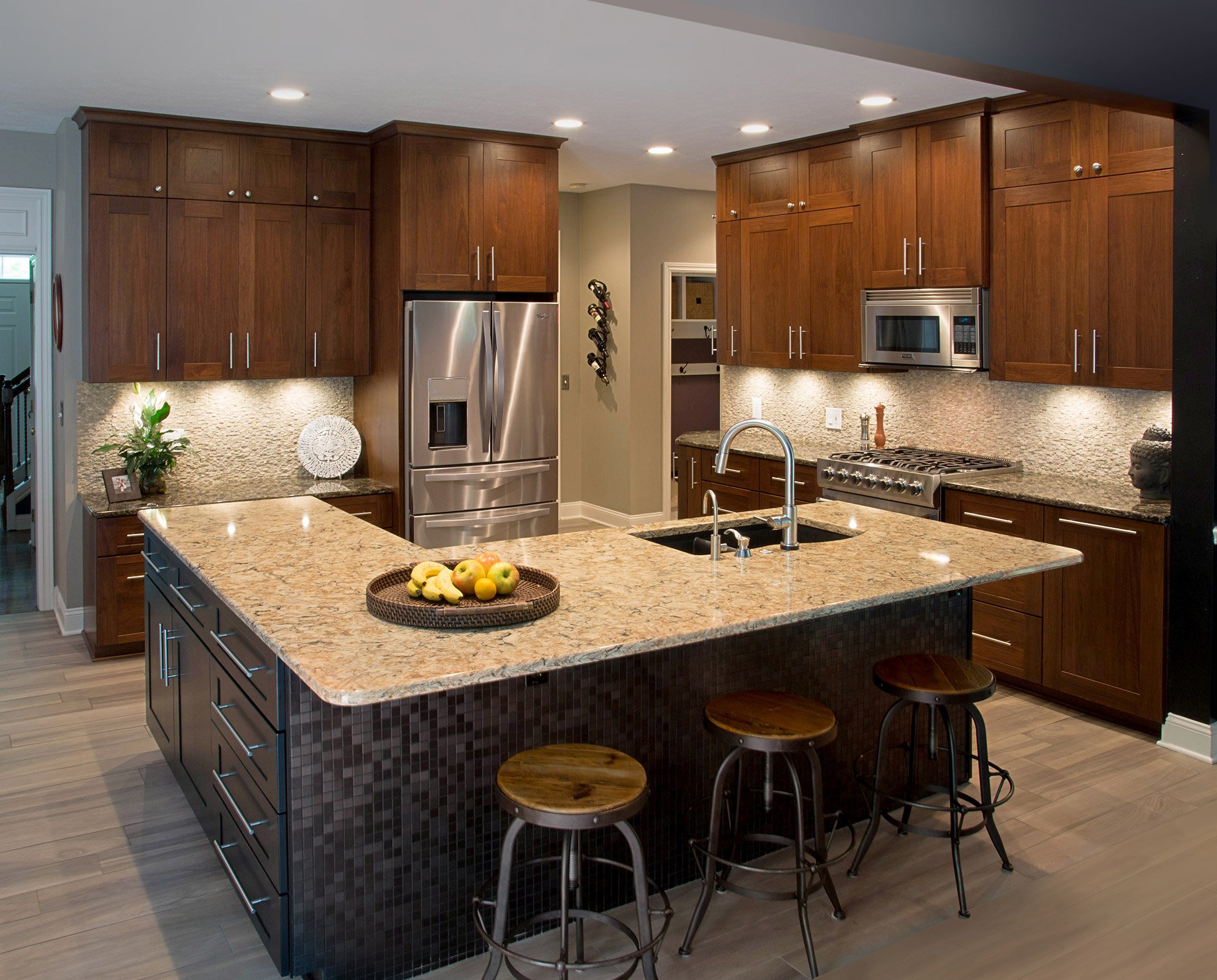 A set of cherry wood cabinets and a kitchen island