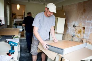 Kitchen worker is doing the cabinet refacing 