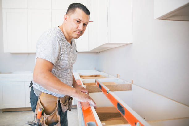 Worker installing Customize kitchen cabinet reface.