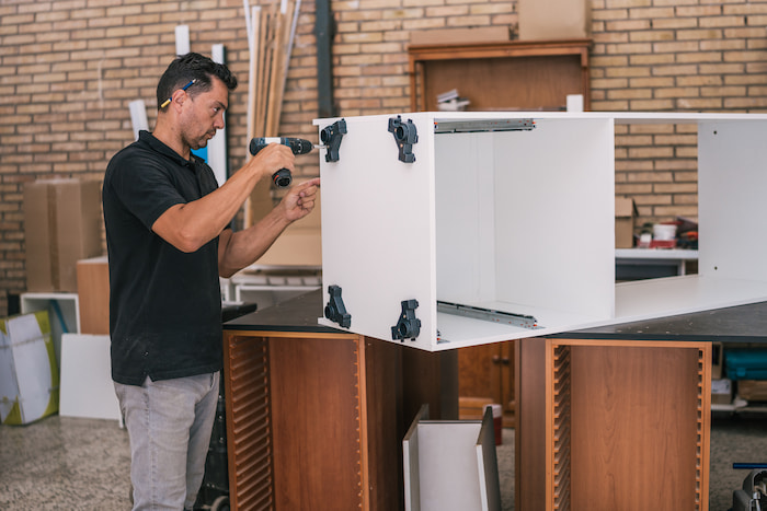 wood refacing expert repairing cabinet to extend its lifespan