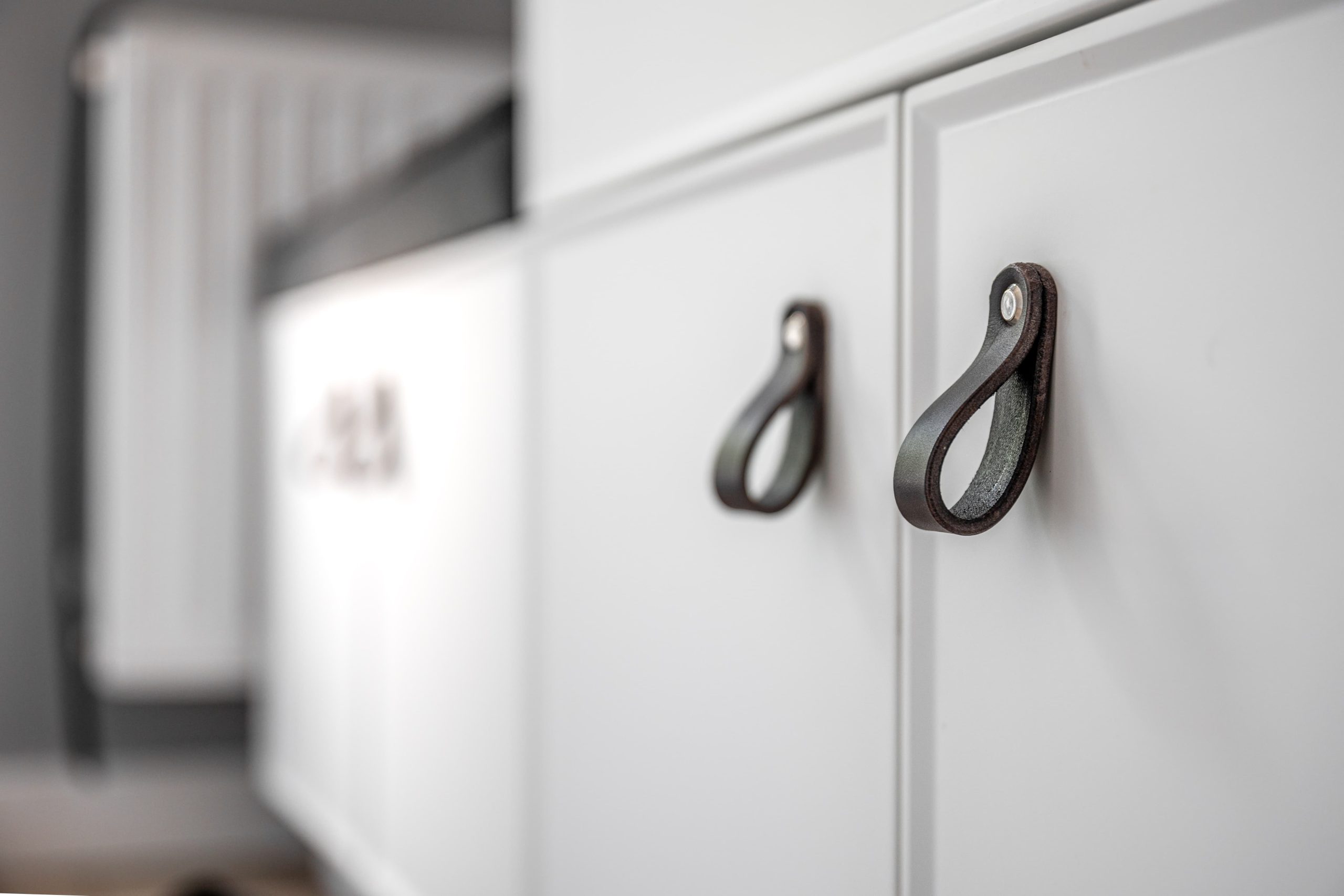 white kitchen cabinets with black handles