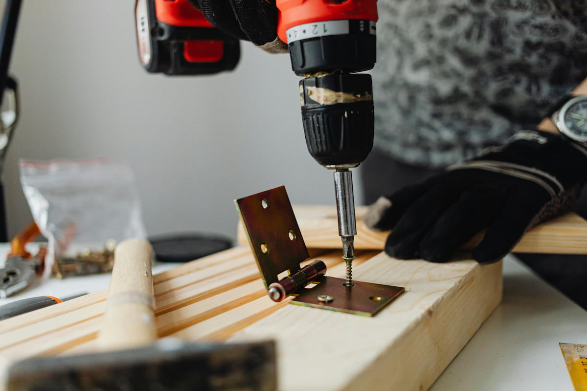 Close-up View of Drilling Hinge into Wood
